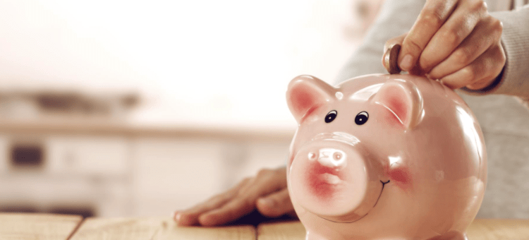a woman topping up her pension by saving a deposit in a piggy bank